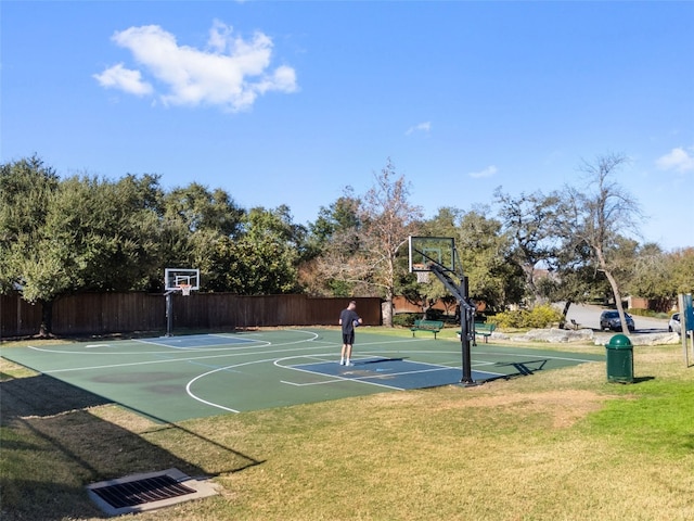 view of sport court with a yard