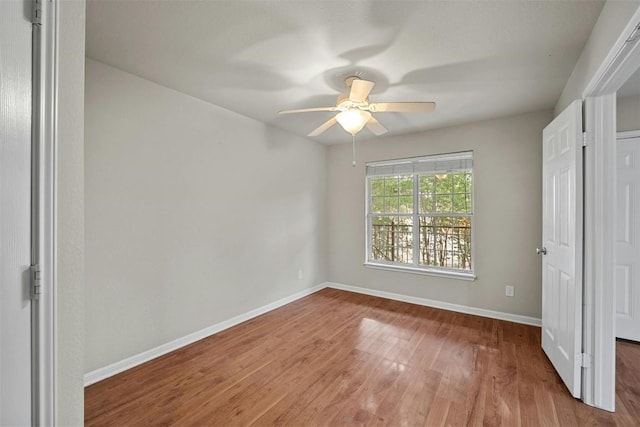 unfurnished bedroom with ceiling fan and light hardwood / wood-style flooring