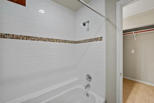 bathroom with tiled shower / bath combo and tile patterned floors