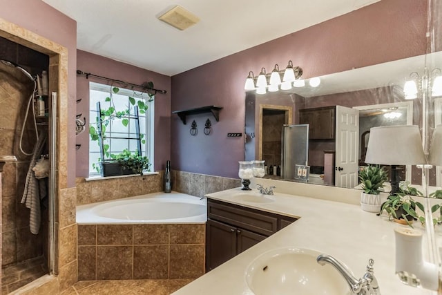 bathroom featuring tile patterned flooring, vanity, and shower with separate bathtub