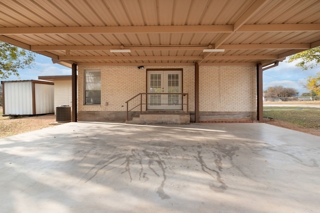 view of patio featuring a shed, a carport, and cooling unit