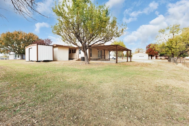 view of yard featuring a carport and central air condition unit