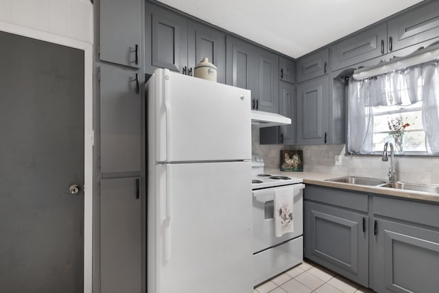 kitchen featuring white appliances, sink, decorative backsplash, gray cabinets, and light tile patterned floors