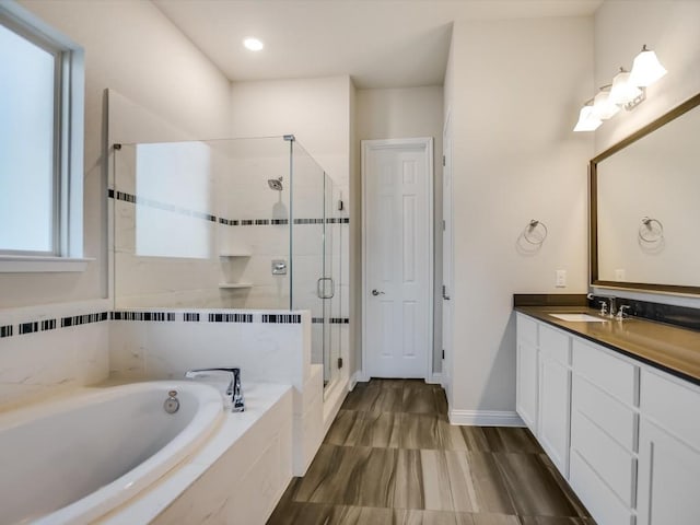 bathroom featuring plus walk in shower and vanity