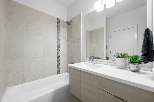 bathroom with vanity and tiled shower / bath