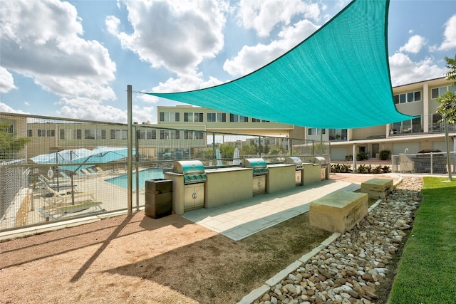 view of community with area for grilling and a swimming pool