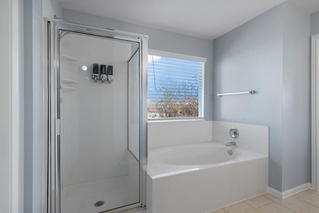 bathroom with tile patterned floors and shower with separate bathtub