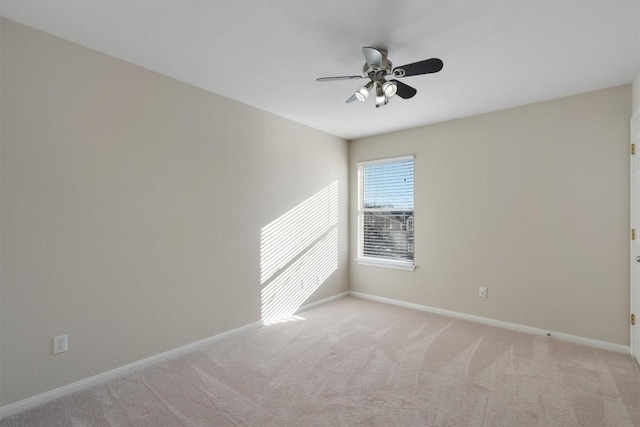 unfurnished room with ceiling fan and light colored carpet