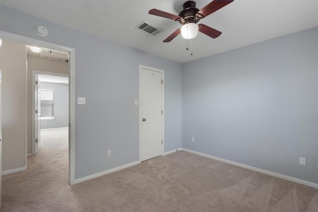 unfurnished bedroom featuring light carpet and ceiling fan