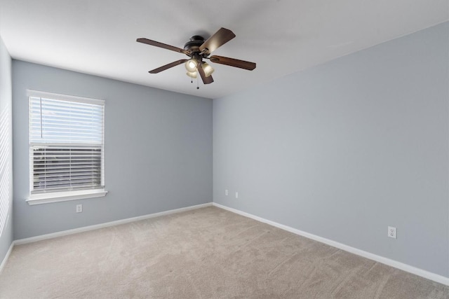 carpeted spare room with ceiling fan