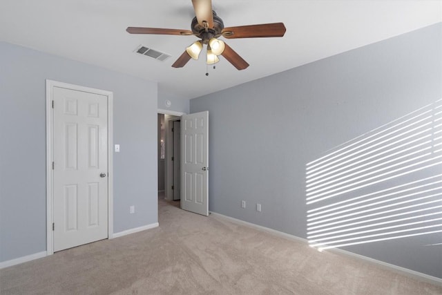 unfurnished bedroom featuring ceiling fan and light colored carpet