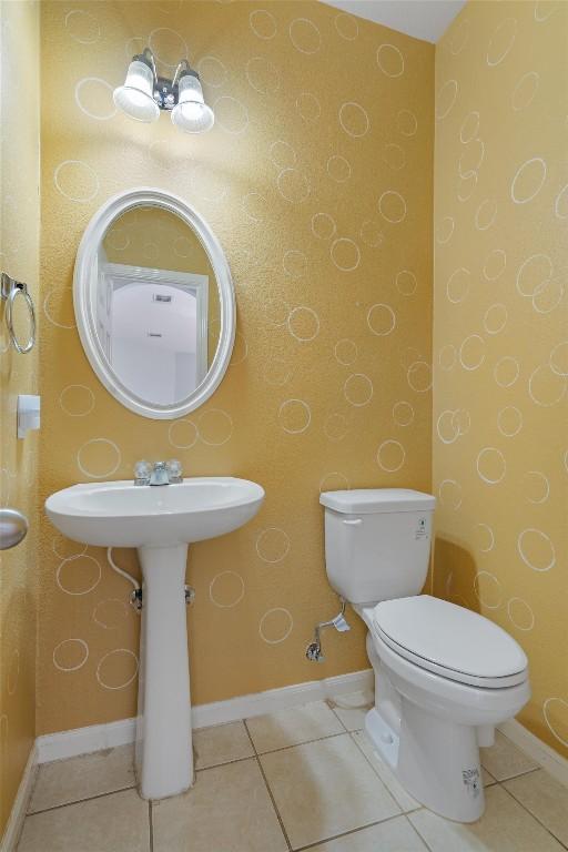 bathroom with tile patterned flooring and toilet