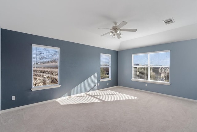 empty room featuring light colored carpet, ceiling fan, and lofted ceiling