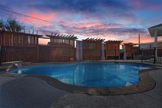 pool at dusk featuring pool water feature