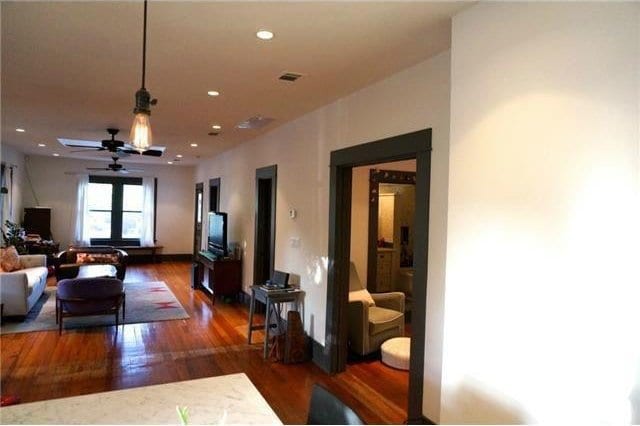 living room featuring dark hardwood / wood-style floors, ceiling fan, and french doors