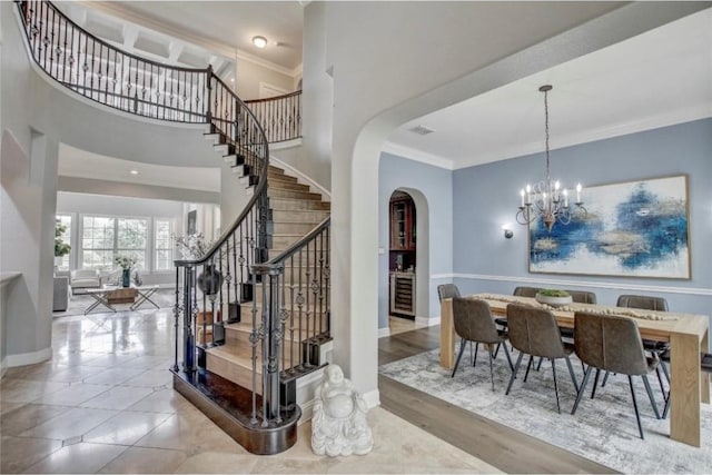 interior space featuring wine cooler, an inviting chandelier, and crown molding