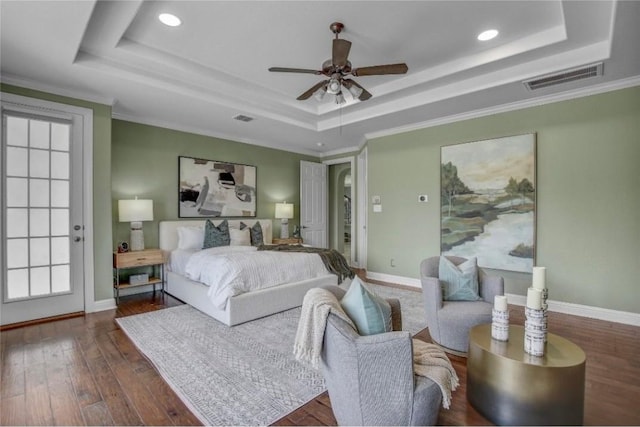 bedroom with a tray ceiling, ceiling fan, and ornamental molding