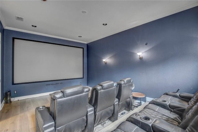 cinema room with crown molding and hardwood / wood-style floors