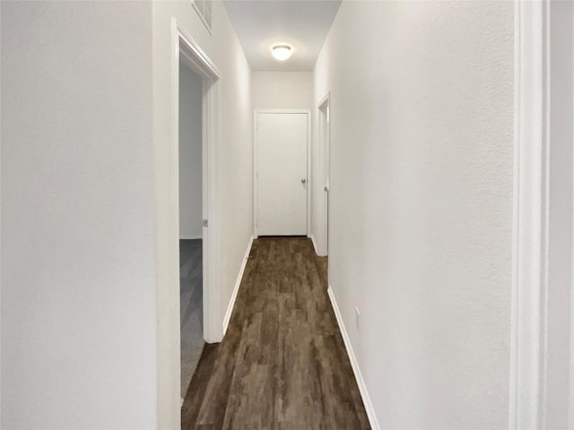 corridor featuring dark hardwood / wood-style flooring