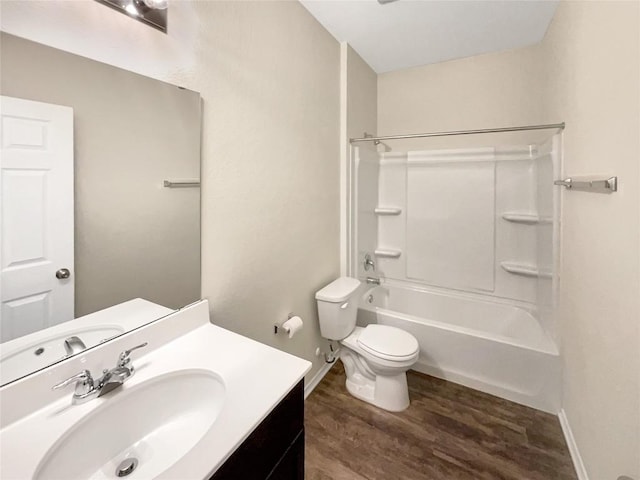 full bathroom with shower / bathing tub combination, vanity, hardwood / wood-style flooring, and toilet