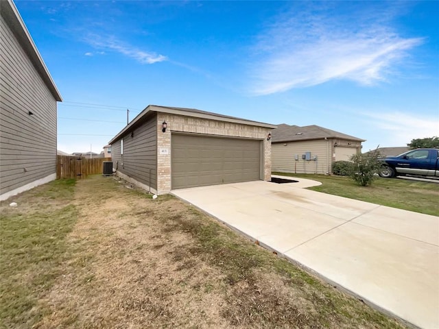 exterior space featuring central AC, a yard, an outdoor structure, and a garage