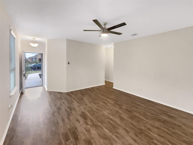 spare room featuring ceiling fan and dark hardwood / wood-style flooring