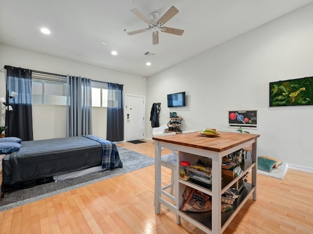 bedroom with ceiling fan and light hardwood / wood-style flooring