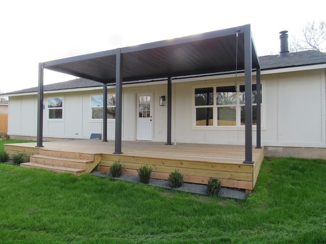 rear view of house featuring a lawn