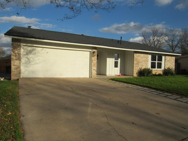 ranch-style house with a front yard and a garage