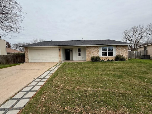 ranch-style house with central air condition unit, a front lawn, and a garage