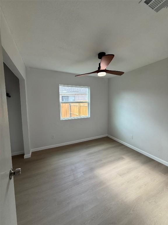 unfurnished room with ceiling fan and light hardwood / wood-style flooring