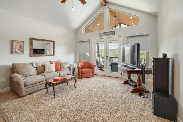 living room featuring ceiling fan, french doors, beamed ceiling, high vaulted ceiling, and carpet floors