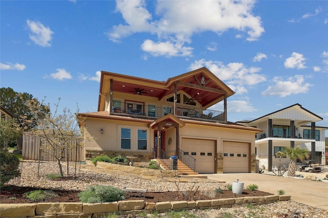 view of front of home with ceiling fan, a garage, and a balcony