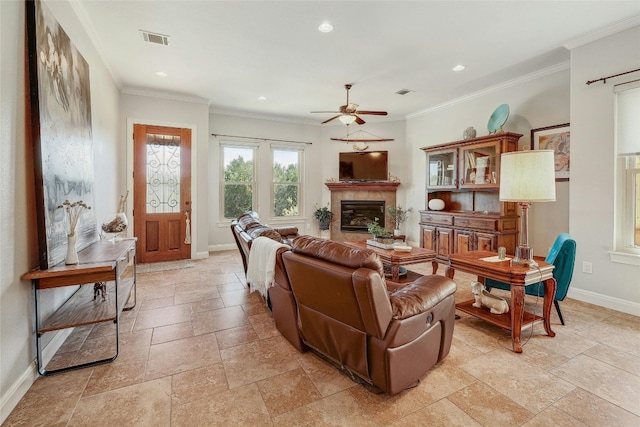 living room featuring ceiling fan and ornamental molding