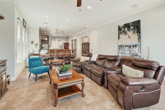 living room with crown molding and ceiling fan