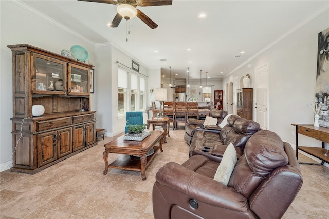 living room with ceiling fan and ornamental molding