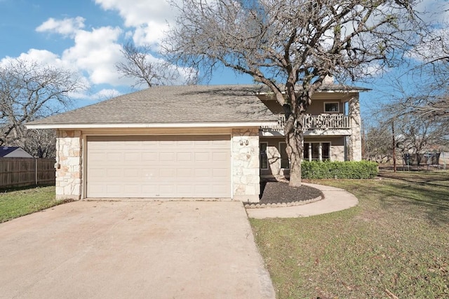 view of front of home featuring a front yard, a balcony, and a garage