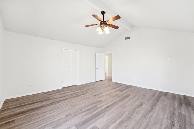 unfurnished room with ceiling fan, beam ceiling, light wood-type flooring, and high vaulted ceiling