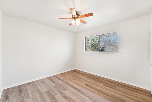 empty room featuring ceiling fan and light hardwood / wood-style flooring