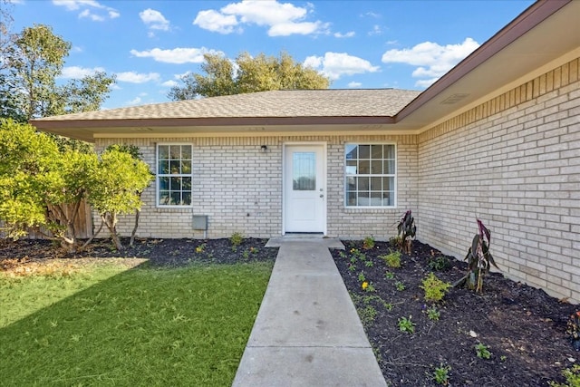 doorway to property featuring a yard