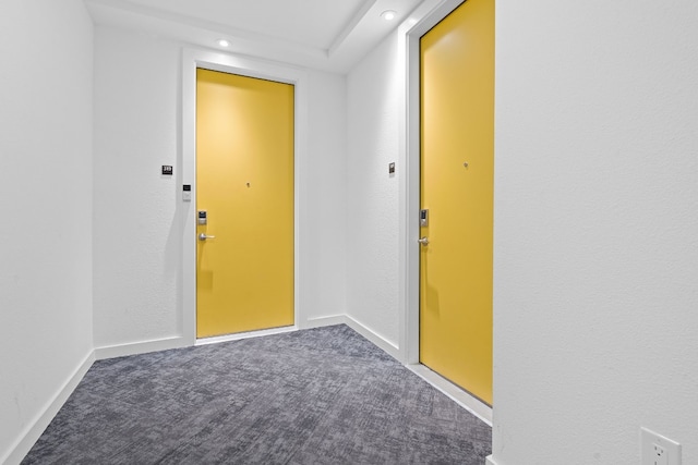 doorway to outside featuring dark carpet