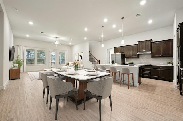 dining room with ceiling fan and light wood-type flooring