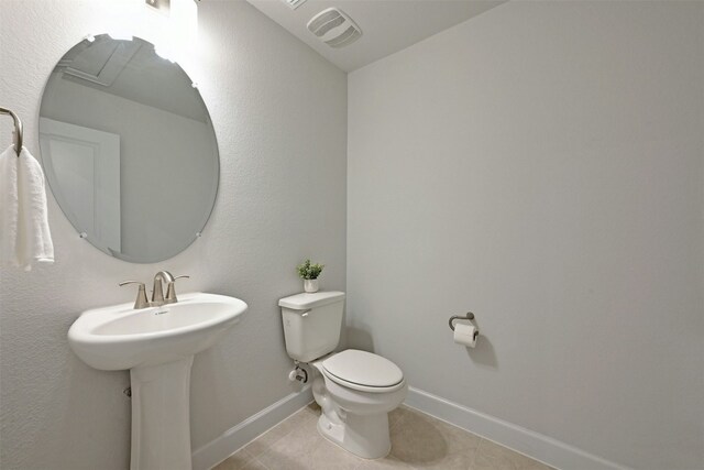 bathroom featuring tile patterned floors and toilet