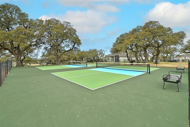 view of tennis court with basketball hoop