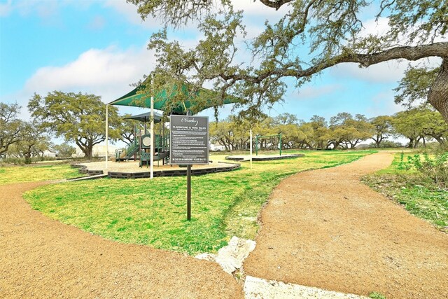 view of property's community with a playground and a lawn