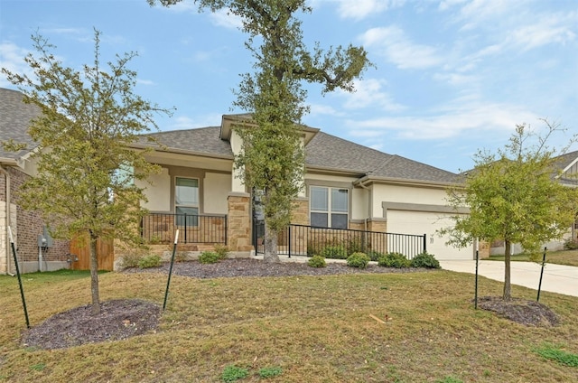 view of front of home with a garage and a front lawn