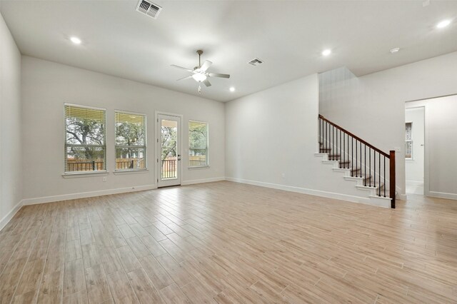 unfurnished living room with ceiling fan