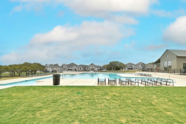 view of pool featuring a lawn