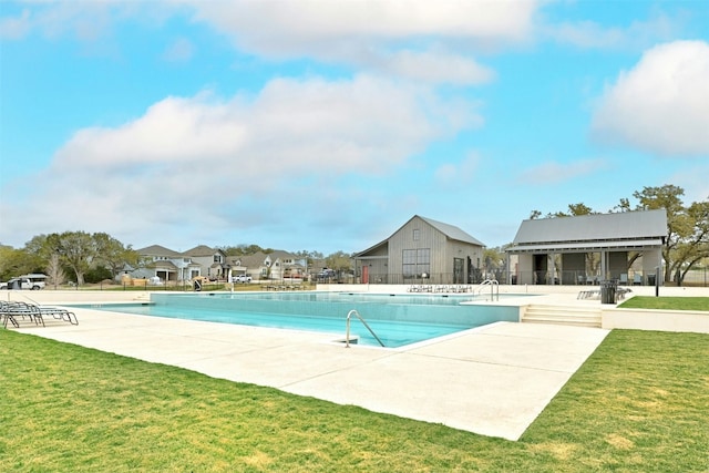 view of swimming pool featuring a patio area and a lawn