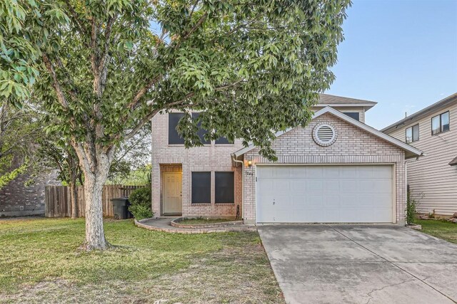 view of front of property with a front yard and a garage